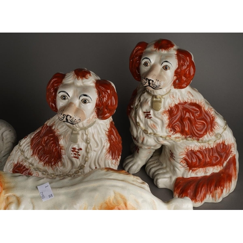 93 - Five various Staffordshire dogs including an almost pair of large seated white Spaniel decorated wit... 
