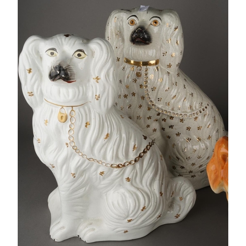 93 - Five various Staffordshire dogs including an almost pair of large seated white Spaniel decorated wit... 