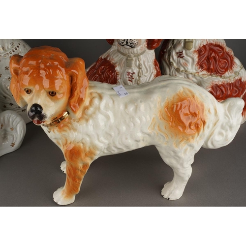 93 - Five various Staffordshire dogs including an almost pair of large seated white Spaniel decorated wit... 