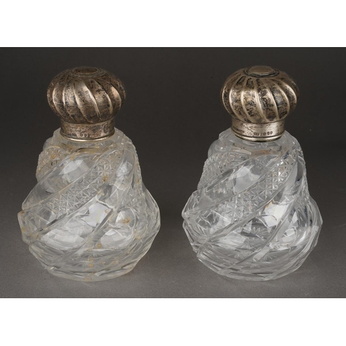 277 - A pair of Victorian trapezoid shaped hobnail cut glass silver mounted scent bottles, with wyvern flu... 