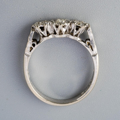 295 - A 9ct gold diamond three stone ring. Set with round brilliant cut diamonds within illusion style set... 