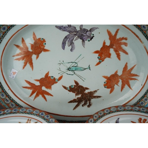 122 - A set of twelve Chinese dinner plates and matching oval platter, each decorated with carp and shrimp... 