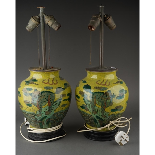 123 - A pair of Chinese baluster vases, each lime green ground decorated with Mythical beasts standing on ... 