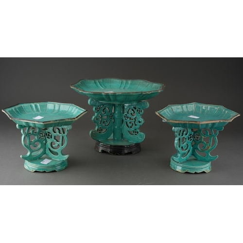 128 - A matched garniture of Chinese turquoise glazed dishes on stands, shaped octagonal moulded dishes ov... 