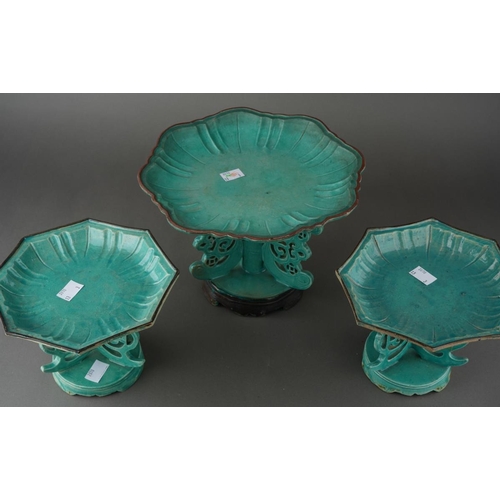 128 - A matched garniture of Chinese turquoise glazed dishes on stands, shaped octagonal moulded dishes ov... 