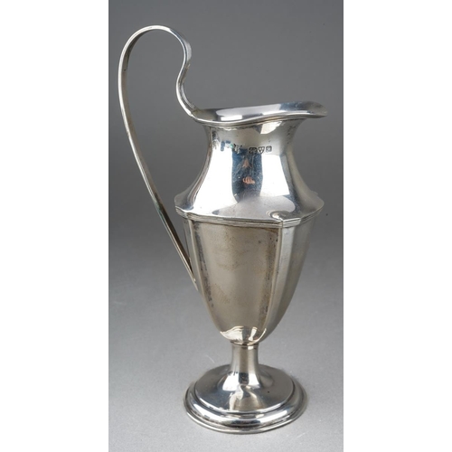 203 - An Edwardian Neo-Classical silver urn shaped cream jug with reeded handle on raised foot, hallmarked... 