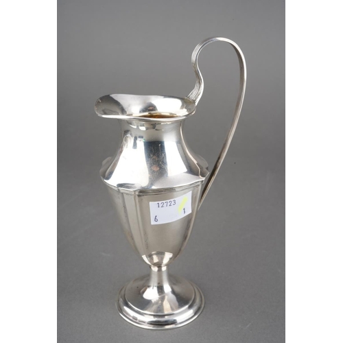 203 - An Edwardian Neo-Classical silver urn shaped cream jug with reeded handle on raised foot, hallmarked... 