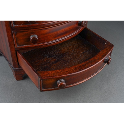 206 - A reproduction miniature mahogany bow front chest of four graduated drawers in the early 19th centur... 