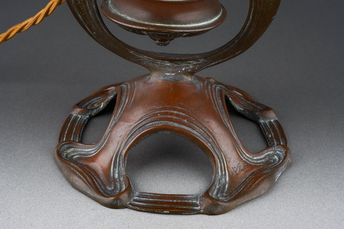 In the manner of Benson, an Art Nouveau brass gimbal table lamp, the ...