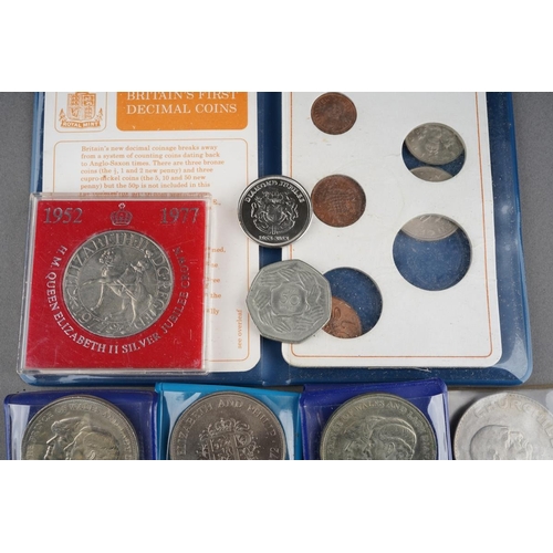 323 - A collection of coins to include Britain's first decimal coin set, crowns, Churchill, commemorative ... 