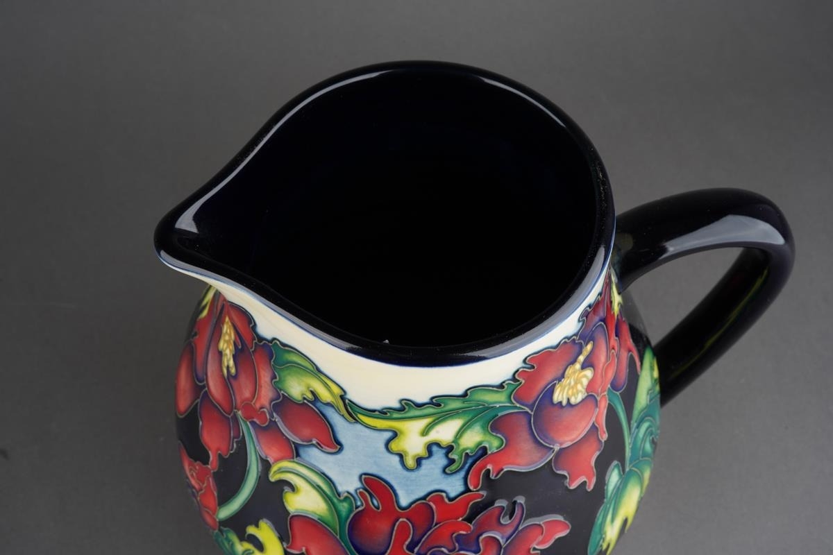 A Moorcroft Trial Red Flower pitcher jug, red flowers against black ...