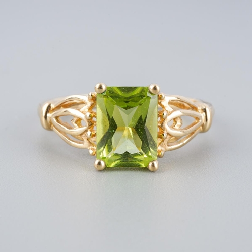 A 9ct gold peridot single stone ring. Hallmarked 9ct gold, sponsors ...
