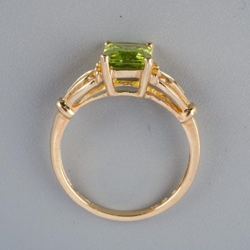 A 9ct gold peridot single stone ring. Hallmarked 9ct gold, sponsors ...