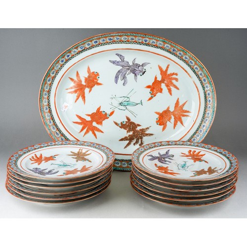 122 - A set of twelve Chinese dinner plates and matching oval platter, each decorated with carp and shrimp... 