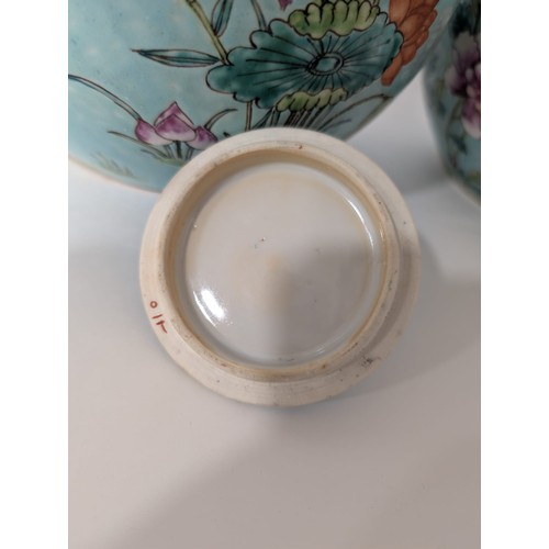 129 - A pair of 20th Century Chinese large globular ginger jars and covers, decorated in the Famille Rose ... 