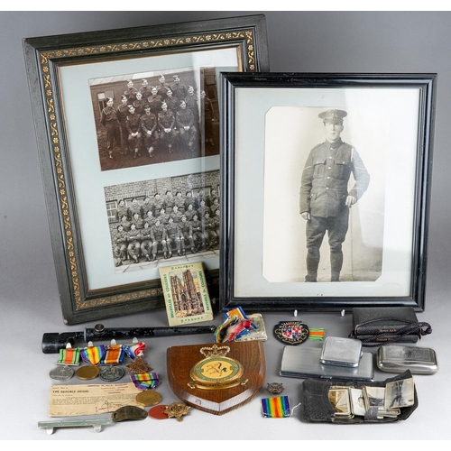 2 - A collection of WWI and WWII militaria, comprising a set of four medals on a bar, the WWI medals nam... 
