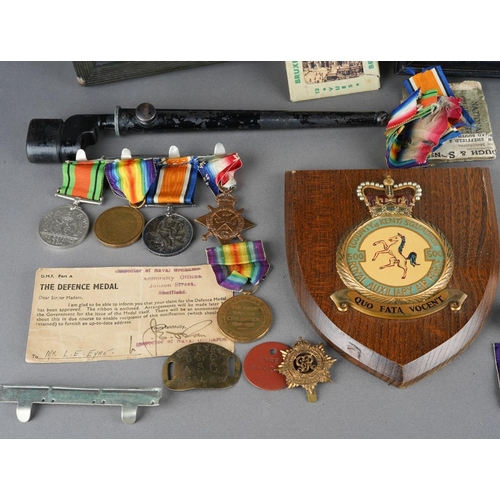 2 - A collection of WWI and WWII militaria, comprising a set of four medals on a bar, the WWI medals nam... 