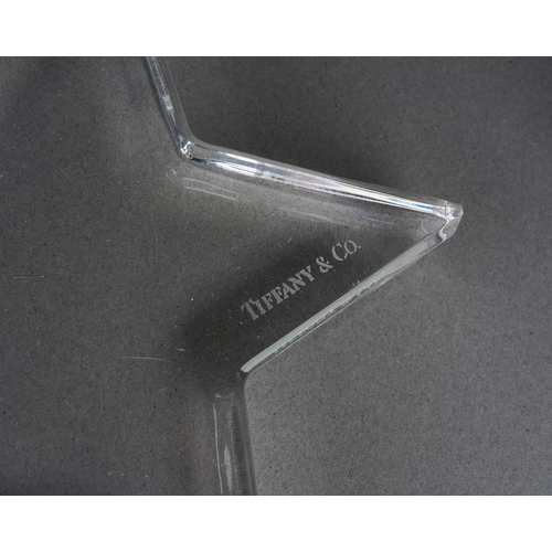 44 - Four pieces of Tiffany & Co glassware, comprising a star shaped paperweight, two flattened points to... 