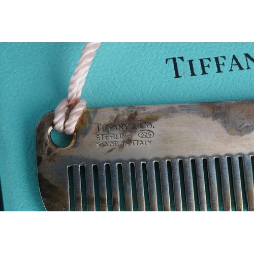55 - A boxed Tiffany & Co sterling purse comb with pink silk tassel attached, stamped 