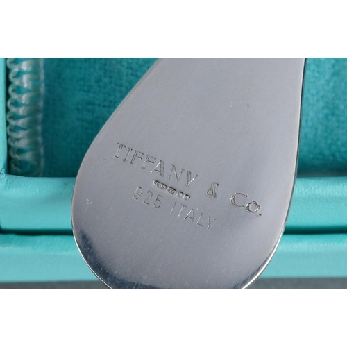 55 - A boxed Tiffany & Co sterling purse comb with pink silk tassel attached, stamped 