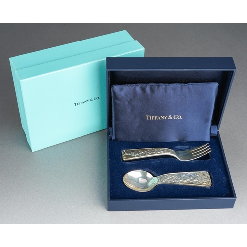 62 - A boxed Tiffany& Co sterling silver christening set spoon and fork, the handles cast with bears and ... 