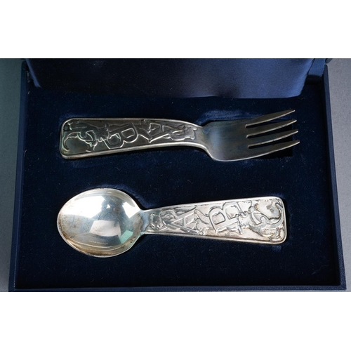 62 - A boxed Tiffany& Co sterling silver christening set spoon and fork, the handles cast with bears and ... 