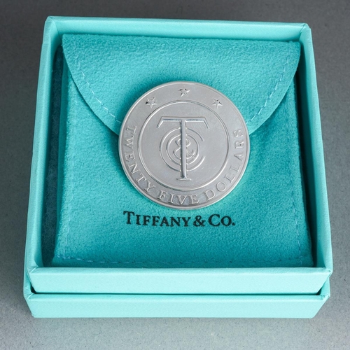 63 - A boxed Tiffany & Co Twenty Five Dollars token, the reverse stamped 