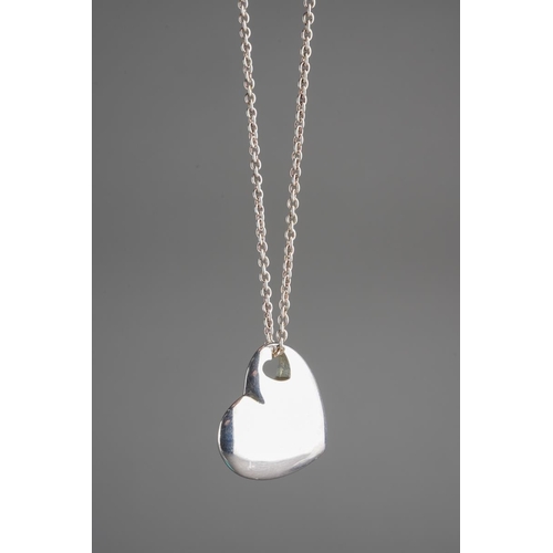 73 - A boxed Tiffany & Co silver heart shaped pendant on chain, the pendant with heart shaped hole stampe... 
