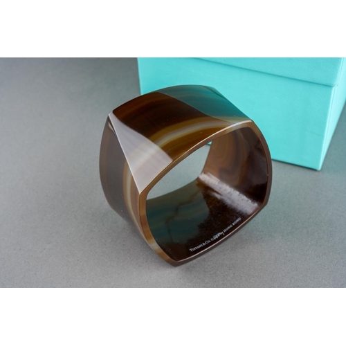 74 - A boxed Tiffany & Co banded agate torque bangle designed by Frank Gehry, an interior edge marked 