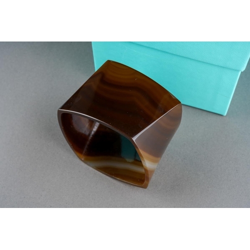 74 - A boxed Tiffany & Co banded agate torque bangle designed by Frank Gehry, an interior edge marked 