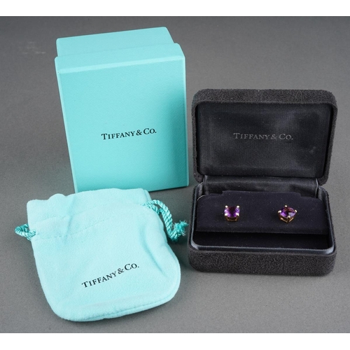 78 - TIFFANY & CO. a pair of amethyst 'sparkler' single stone ear studs. Each ear stud set with an amethy... 