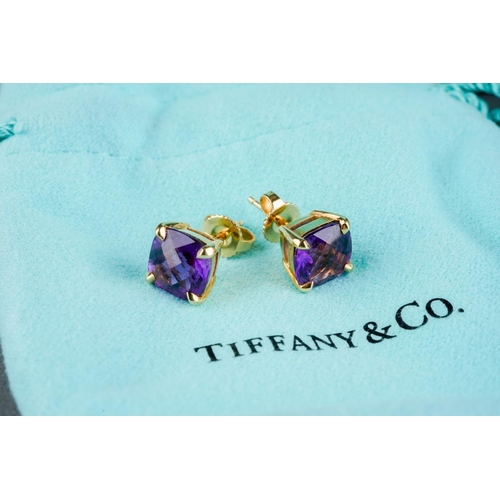 78 - TIFFANY & CO. a pair of amethyst 'sparkler' single stone ear studs. Each ear stud set with an amethy... 