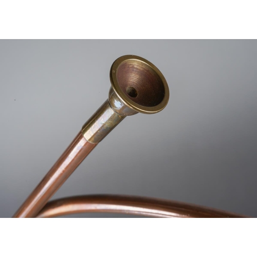 430 - Two copper and brass coaching horns one of scrolled circulour form the other straight (74 cm long ap... 