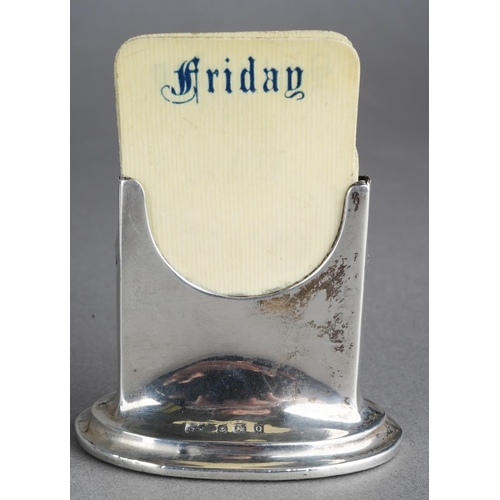 458 - A George V silver perpetual calendar of rectangular form on an oval loaded base, fitted with removab... 