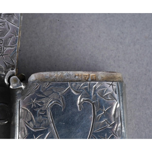 477 - A late Victorian silver vesta case of rectangular form, with engraved decoration, London 1900, with ... 