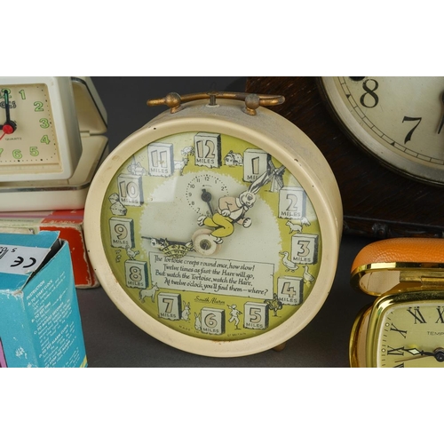 498 - Assorted clocks to include: a 1950s Smith Alarm Hare and Tortoise alarm clock with verse and picture... 