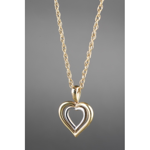 539 - A 9ct gold pendant and chain. The yellow and white 9ct gold heart shape pendant, suspended from a 9c... 