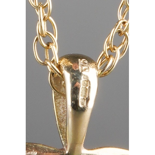 539 - A 9ct gold pendant and chain. The yellow and white 9ct gold heart shape pendant, suspended from a 9c... 