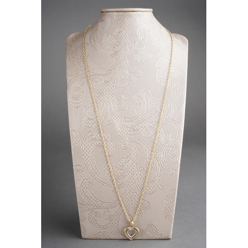 539 - A 9ct gold pendant and chain. The yellow and white 9ct gold heart shape pendant, suspended from a 9c... 