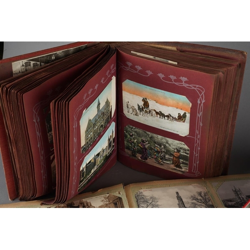 699 - A tin containing various post cards and albums of tea cards and two albums of early 20th century and... 