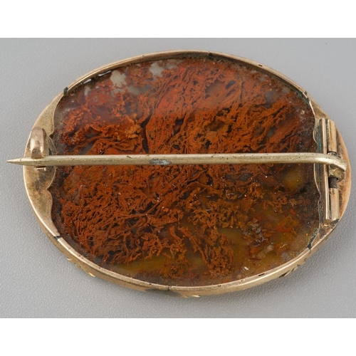 730 - An antique gold agate brooch. The moss agate panel, with a yellow metal surmount, mount unmarked, as... 