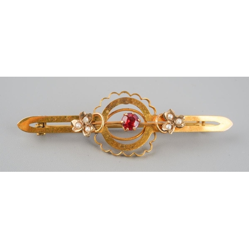 733 - An antique gem set brooch. Set with a garnet topped doublet and seed pearl accents, brooch assessed ... 