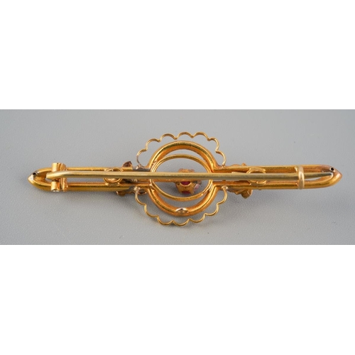 733 - An antique gem set brooch. Set with a garnet topped doublet and seed pearl accents, brooch assessed ... 