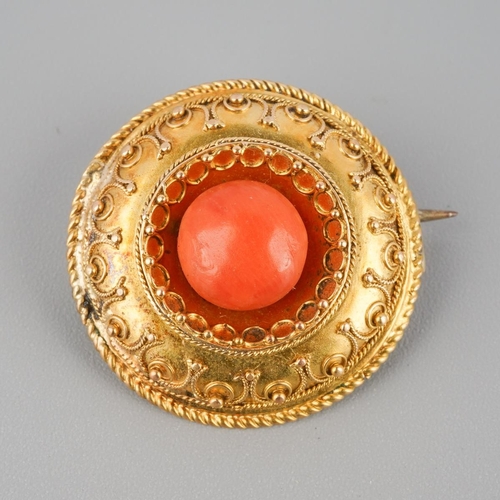 744 - A late Victorian gold coral brooch. The coral bead, within a cannetille surmount, brooch unmarked, a... 