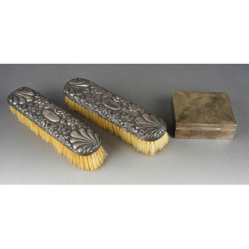 1028 - A pair of later Victorian silver mounted clothes brushes, chased with flowers and shell, hallmarked ... 