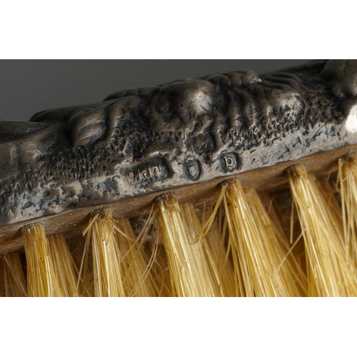 1028 - A pair of later Victorian silver mounted clothes brushes, chased with flowers and shell, hallmarked ... 