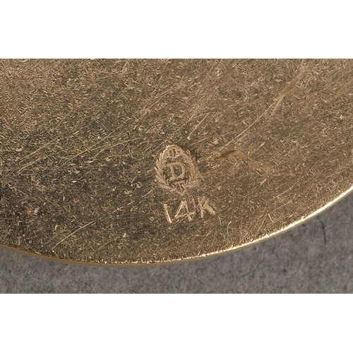 1067 - Two American Dankner charms. To include a floral charm (stamped 14k, sponsors mark rubbed), together... 