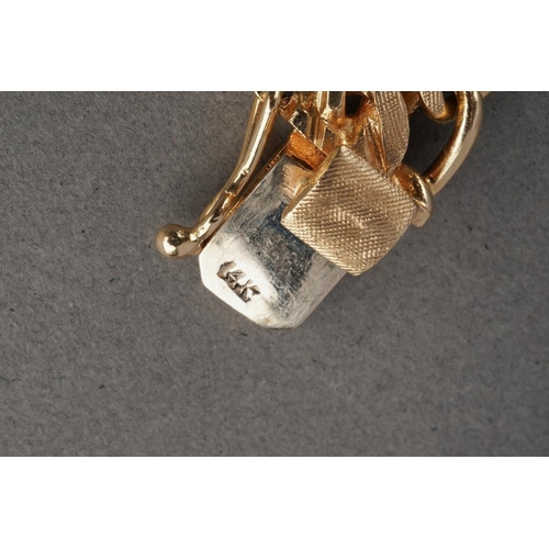 1070 - An American charm bracelet with charms attributed to Dankner. The solid fancy curb link chain suspen... 