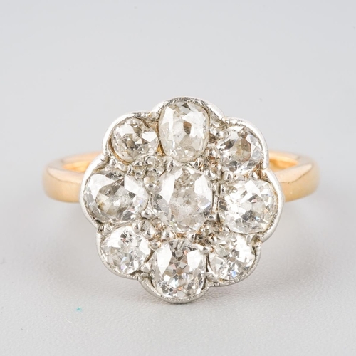 1078 - An early 20th century platinum and 18ct gold diamond cluster ring. Set throughout with old cut diamo... 