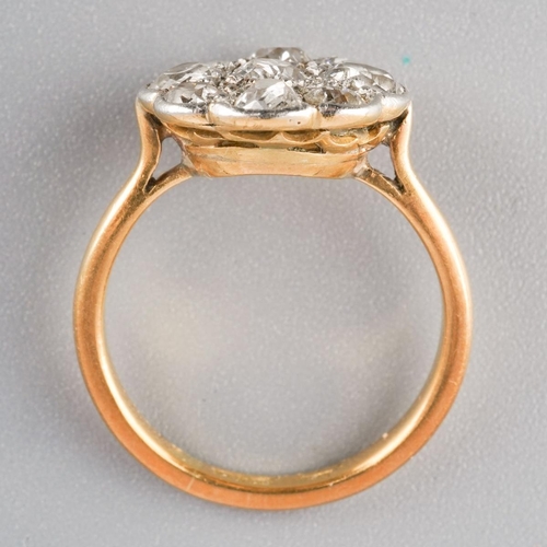 1078 - An early 20th century platinum and 18ct gold diamond cluster ring. Set throughout with old cut diamo... 